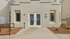 Huachuca City apartment for rent - A building with a white door and windows with brown frames.