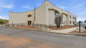 Huachuca City apartment for rent - A modern building with a flat roof and a parking lot in front.
