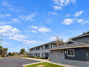 Chino Valley apartment for rent - A parking lot in front of a building with grey walls.