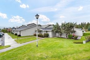 Colville apartment for rent - the view of a gray house with a yard and street light