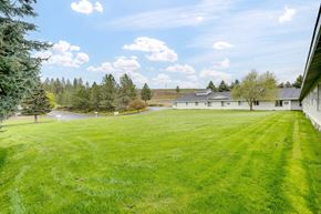 Colville apartment for rent - a large yard with a house in the background