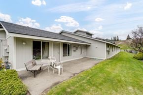 Colville apartment for rent - a patio with a table and chairs in front of a house