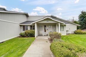 Colville apartment for rent - the front of a white house with a sidewalk and grass