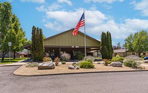 Grants Pass apartment for rent - a building with an flag in front of it