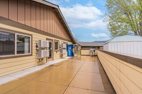 Talent apartment for rent - the entrance to a building with a patio and air conditioning units on the side