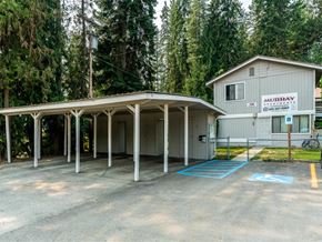 Priest River apartment for rent - a covered parking lot in front of a car garage