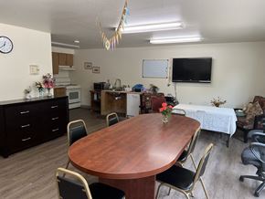 Prosser apartment for rent - a dining room with a table and a kitchen with a tv