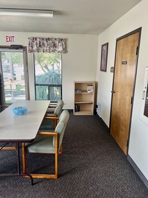Cle Elum apartment for rent - a conference room with a table and chairs and a exit door