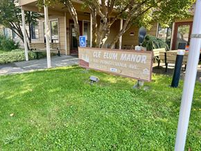 Cle Elum apartment for rent - a sign in the grass in front of a building
