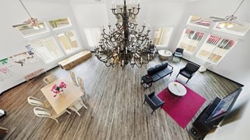 Huachuca City apartment for rent - A dining room with a chandelier, a table with chairs, and pictures on the wall.