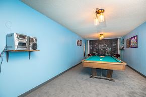 La Grande apartment for rent - A room with a pool table and a vintage camera on the wall.