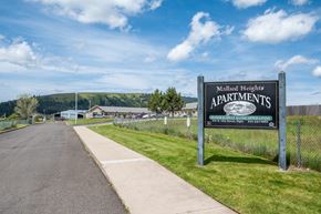 Elgin apartment for rent - A sign for Mallard Heights Apartments is displayed in front of a road.