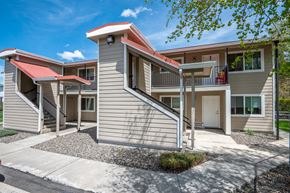 Enterprise apartment for rent - an exterior view of a building with stairs and a driveway
