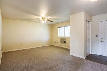 Union apartment for rent - an empty living room with a ceiling fan and a door