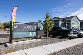 Hermiston apartment for rent - a sign for moorestown apartments with a truck parked in front of a building