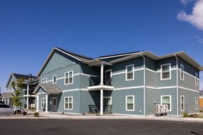 Hermiston apartment for rent - a large blue house with a street in front of it