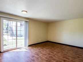Hermiston apartment for rent - an empty living room with wood flooring and a sliding glass door