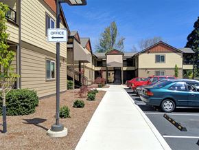 Jacksonville apartment for rent - a sidewalk in front of an office building with cars parked