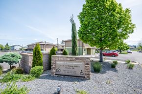 Molalla apartment for rent - The sign in front of the building says "The Greens at Spring Apartments".