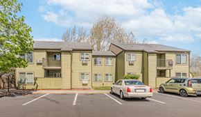 Redmond apartment for rent - an apartment building with cars parked in a parking lot