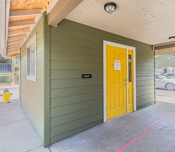 Rogue River apartment for rent - the front door of a green building with a yellow door