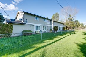 Spirit Lake townhouse for rent - A house with a fence and green lawn in front.