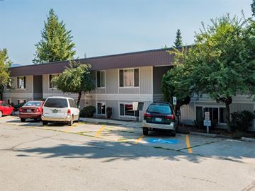 Newport apartment for rent - a parking lot with cars in front of a building