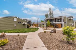 White City apartment for rent - A residential area with a gravel pathway and a few trees.