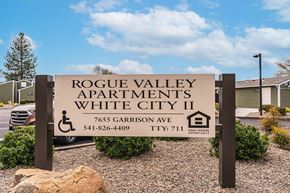 White City apartment for rent - A sign for Rogue Valley Apartments in White City II with a phone number and TTY number.