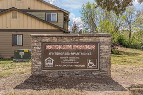 Redmond apartment for rent - A sign for the Wintergreen Apartments stands in front of a building.