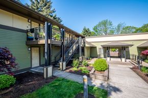 Wilsonville apartment for rent - A sunny day at a residential building with a green lawn and a clear blue sky.