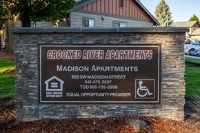 Madras apartment for rent - A sign for Crooked River Apartments with a phone number and address.