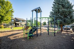 Madras apartment for rent - A playground with a green slide and a brown swing set.