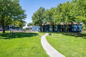 Pendleton apartment for rent - A park with a walking path, grass, and trees.