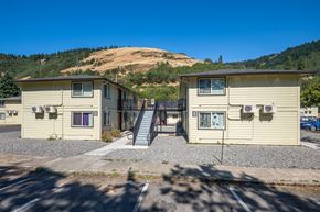White Salmon apartment for rent - A small building with a staircase leading to the entrance.