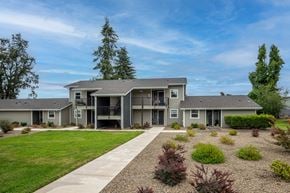Cottage Grove apartment for rent - the view of an apartment building with a yard and a sidewalk