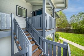 Sutherlin apartment for rent - A house with a grey staircase and a grey railing.