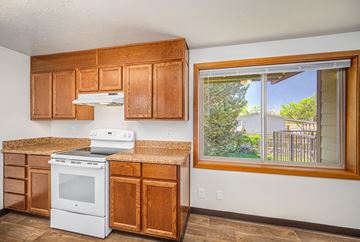 Redmond apartment for rent - A kitchen with wooden cabinets and a white oven.