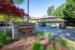 Wilsonville apartment for rent - a building with a sign and cars parked in front of it