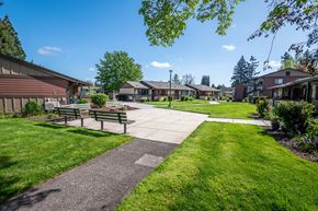 Canby apartment for rent - a park with benches and a sidewalk in front of houses