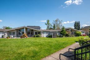Canby apartment for rent - the view of a house with a lawn and a sidewalk