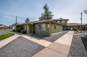 Molalla apartment for rent - a green house with a sidewalk in front of it
