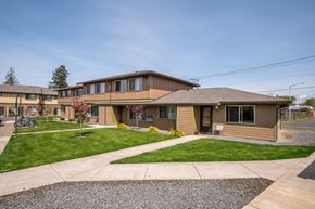 Molalla apartment for rent - a view of the front of a house with a lawn and sidewalk