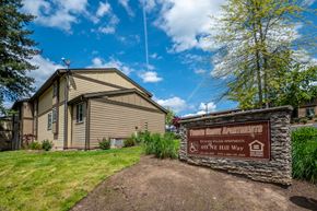 Estacada apartment for rent - a home with a sign and a stone wall