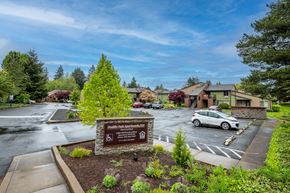 Sherwood apartment for rent - a parking lot with a sign in front of a building