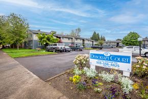Newberg apartment for rent - a sign for the dread court in front of a yard with flowers