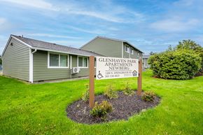 Newberg apartment for rent - a sign in the grass in front of a house