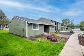 Newberg apartment for rent - a green house with a sidewalk in front of it