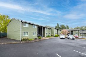 Newberg apartment for rent - our apartments are located on the corner of a parking lot with cars