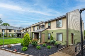 St. Helens apartment for rent - a row of houses with a yard and green grass